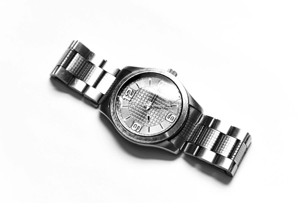 A sleek silver wristwatch displayed on a white background, highlighting its timeless design.