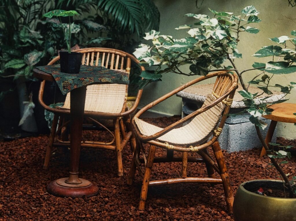 Inviting bamboo chairs and lush greenery in a serene Vietnamese garden setting, perfect for relaxation.