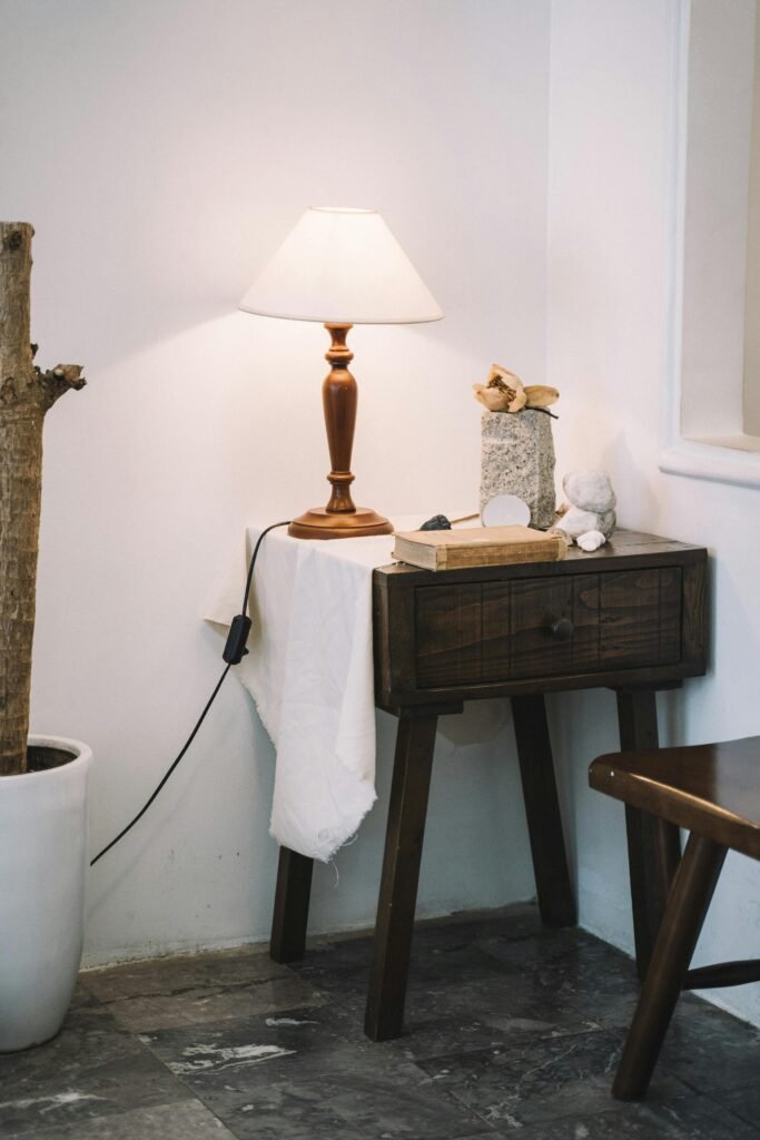 Elegant side table with wooden lamp, perfect for a cozy living room corner.